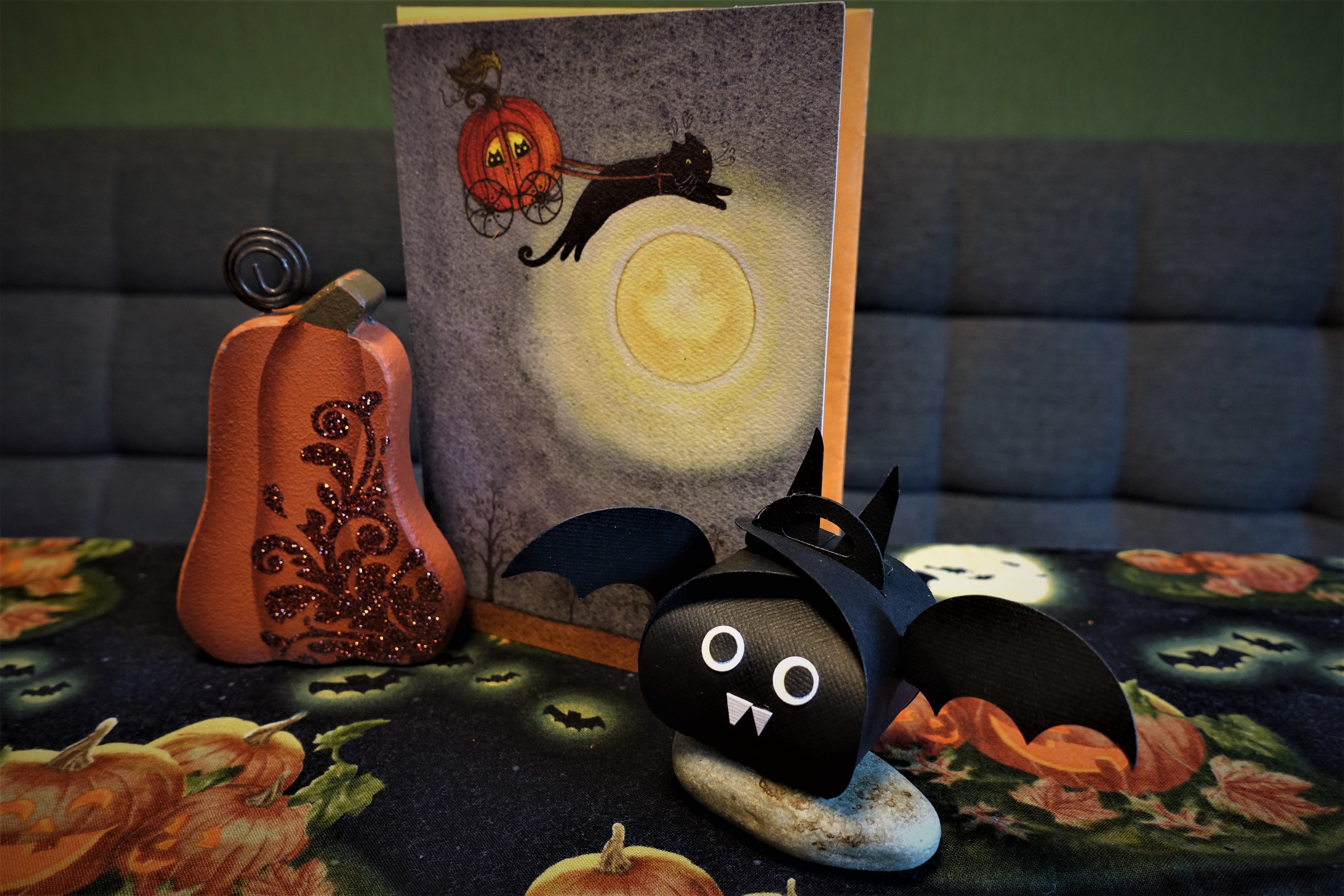 Closed Halloween paper bat box sitting on a decorated table