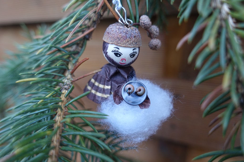 A shepherd ornament holding a sheep